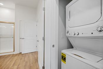 a laundry room with a washer and dryer and a door to a bathroomat Oak Grove at Blake Farm, Wilmington, NC